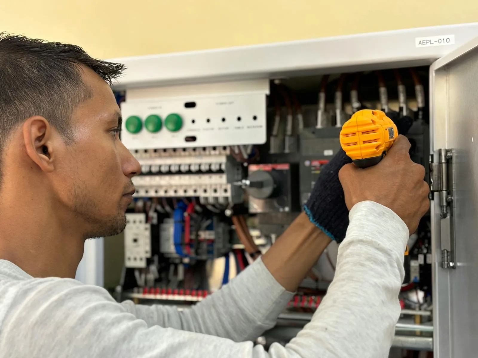 Licensed electrician at work on a residential panel