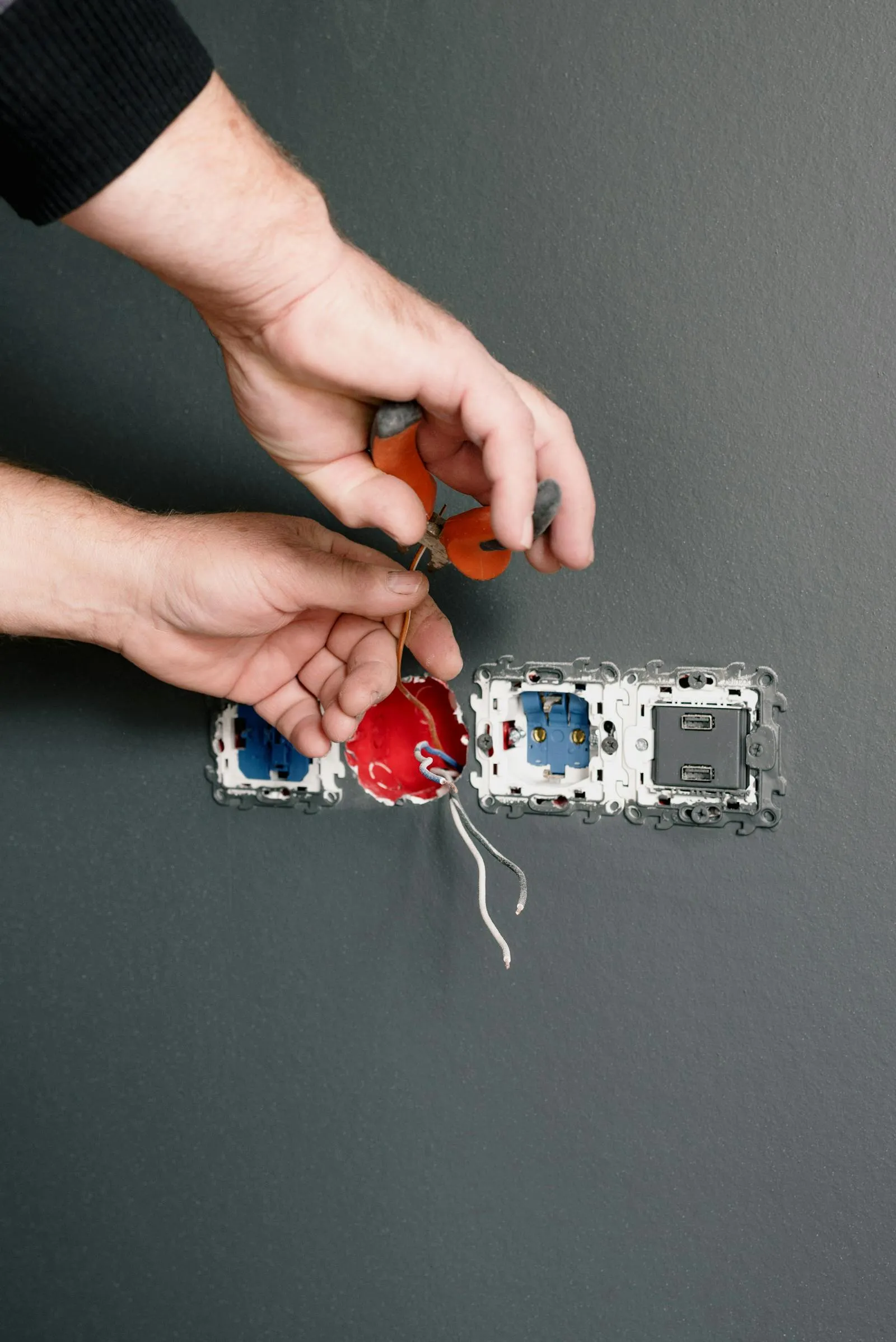 Electrician testing wiring at an outlet